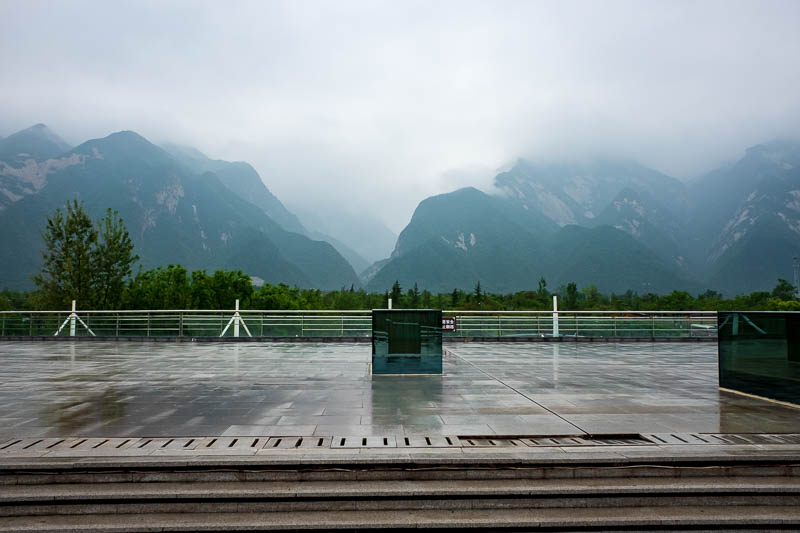 China-Hiking-Rain-Huashan-Soldiers Path - As I got back to the park entrance, the mountains seemed to come out of the fog briefly.