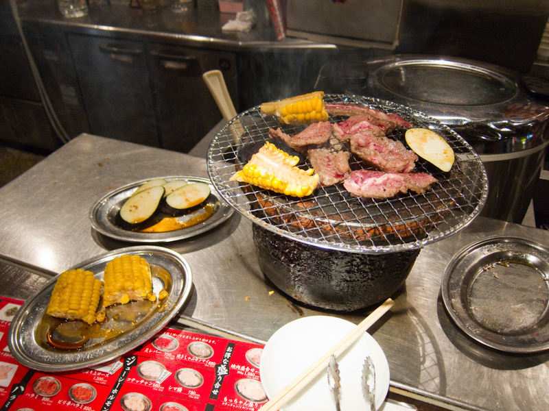 Japan-Tokyo-Kabukicho-Izakaya - This is a charcoal barbecue place where you cook your own. I pointed at the menu and got some beef, corn and eggplant. The guy slices the beef while y