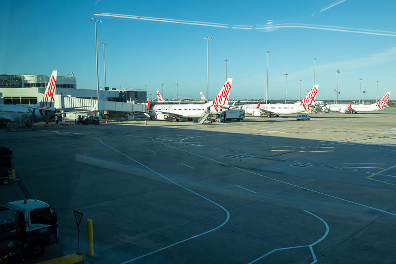 Melbourne-Cairns-Airport-Virgin 737 - And here are some jets (photographed through a blurry window), including mine. I will go all the way to Japan on a tiny 737 Max death plane supplied b