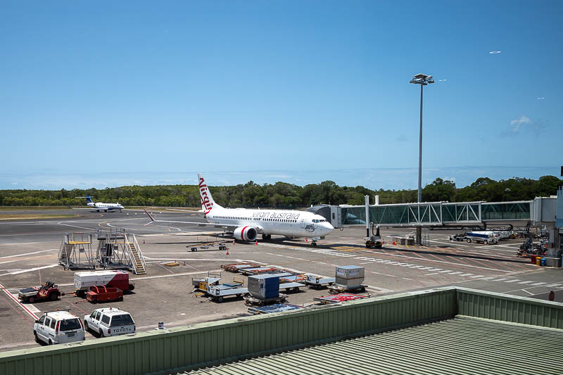 Cairns-Airport - Here is the little 737 max 8 that will take me to Japan. Again this is shot through blurry tinted glass. You can tell it is one of the new faulty Boei