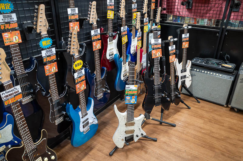 Japan-Kanazawa-Katamachi - I headed into big boss guitar store, which is normally not something I bother to photograph, but those 2 black headless guitars are Schecters, and I n