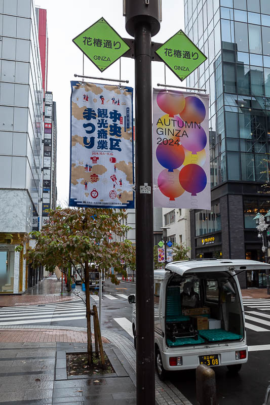 Japan-Tokyo-Garden-Rain - Time to do an environmental rant. Every single light pole in Ginza has these 2 fabric flags affixed advertising the season and some kind of event. The