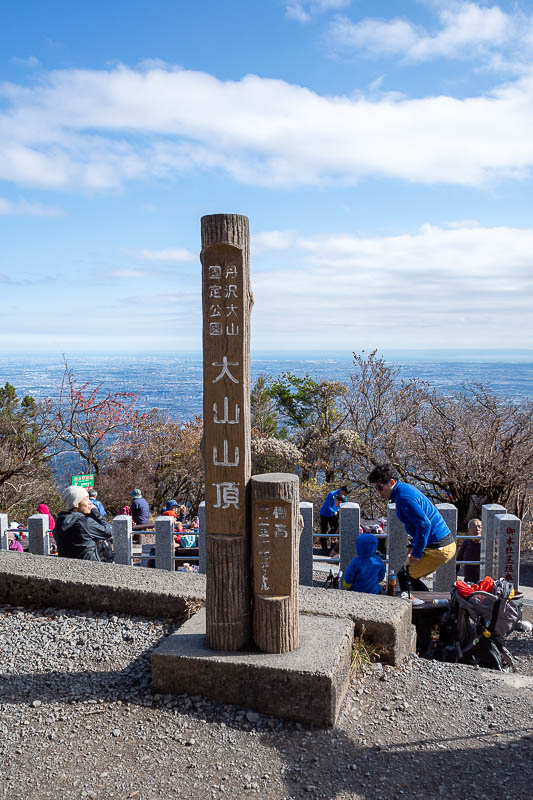 Japan-Tokyo-Hiking-Mount Oyama - Summit marker, a lot of people on the large developed summit area.