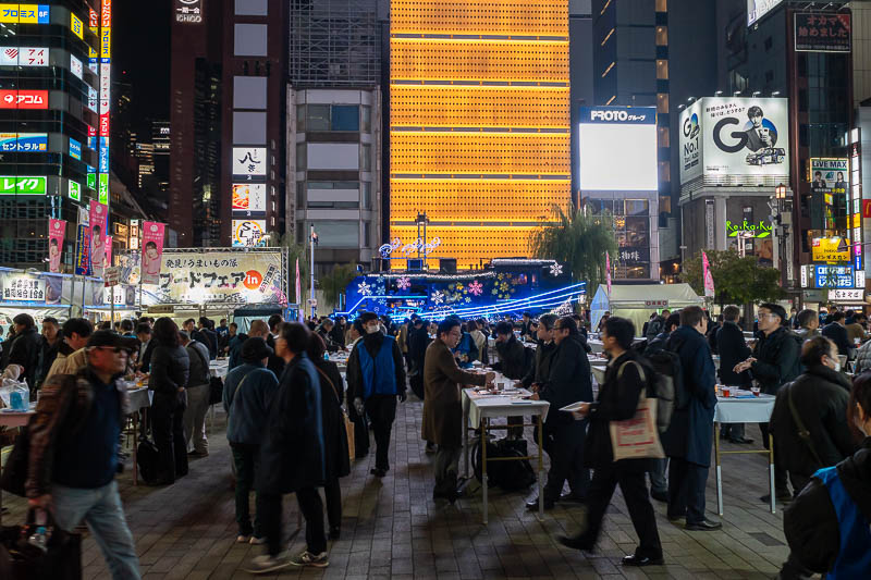 Trip 13 to Japan - October and November 2025 - Some sort of eating festival blocking the view of the train out the front.