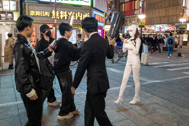 Japan-Tokyo-Shinjuku-Shibuya - There was not a lot of Halloween stuff going on, but this busty mummy with fake boobs was getting filmed wobbling up the street.