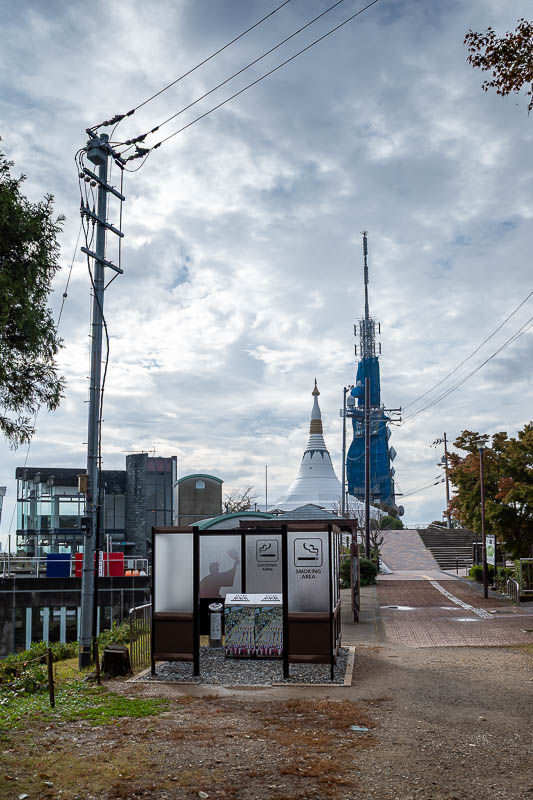 Japan-Tokushima-Castle-Mount Bizan - Once at the top, and here is the promised smoking area, Buddhist facility of some kind, and communication tower covered in blue shade cloth.