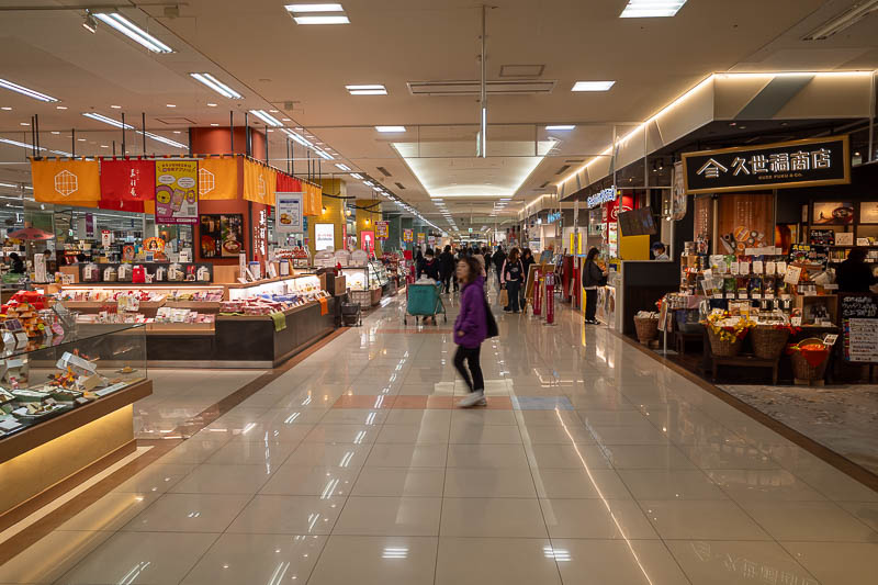 Japan-Takamatsu-Okonomiyaki-Mall - Inside reminds me a bit of a Shinkansen station. Most malls are long and narrow with a hole in the middle between floors. This one was more like a mul