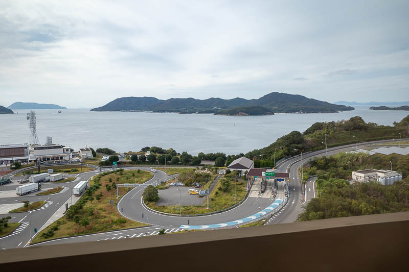 Trip 13 to Japan - October and November 2025 - I will now attempt photos from a moving train. As you go over the bridge, it crosses a couple of small islands. You can exit the bridge (if you are in