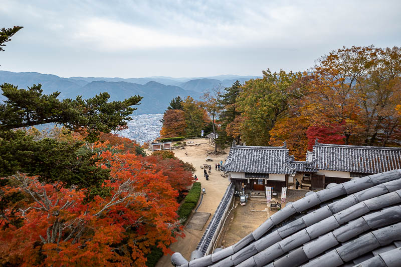 Japan-Okayama-Castle-Hiking - This is the best view you can get of the city below from the castle itself, and it is not a clear view, I had to feed my camera through wooden louvres