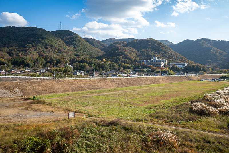 Trip 13 to Japan - October and November 2025 - Finally, a view of the various small mountains from today. The big building on the right is a high school, there were high school kids in uniform on t