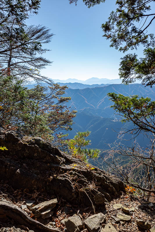 Japan-Tokyo-Hiking-Mount Odake - Rocks and far away mountains make for a good view. Not even a single cloud in the sky today.