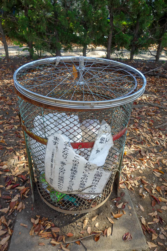 Japan 2015 - Tokyo - Nagoya - Hiroshima - Shimonoseki - Fukuoka - A rubbish bin with a bike wheel for a lid.
