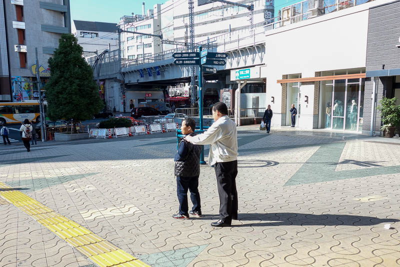 Japan 2015 - Tokyo - Nagoya - Hiroshima - Shimonoseki - Fukuoka - Small boss man insisted on a public shoulder rub to start the morning off. This shows passers by you are a man who deserves respect, despite your near