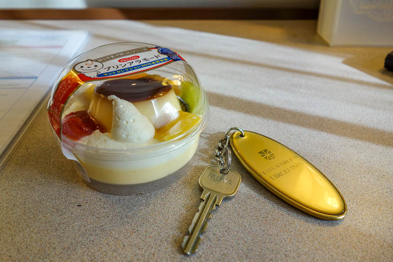 Japan-Nagoya-Hiroshima-Shinkansen - I thought I would have some fruit for lunch. 3 tiny slivers on creme caramel, cake, custard. Also, no door key card here, instead you get an old fashi