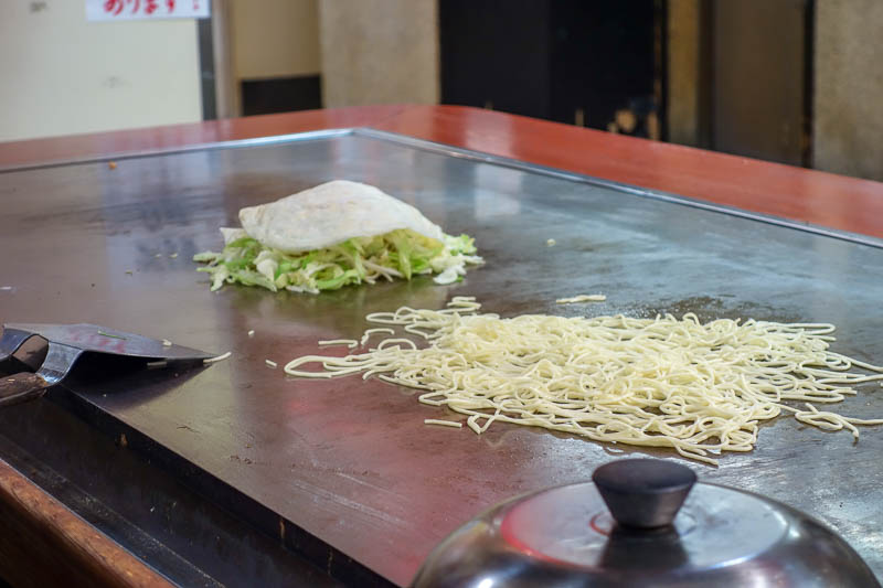 Japan-Hiroshima-Shopping Street-Food-Okonomiyaki - It hasnt really been tourist-a-fied at all. Its quite dirty, you can smoke at the counter whilst eating, noisy, hot, only stairs, plastic stools.