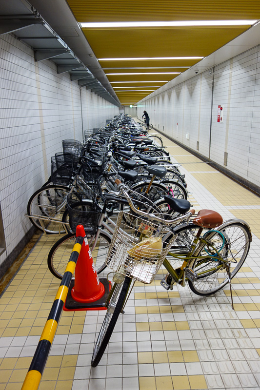 Visiting 9 cities in Japan - Oct and Nov 2016 - I went back under the station through a series of bike filled tunnels. I wanted to take some photos of this tiny fold up bike with wheels no bigger th