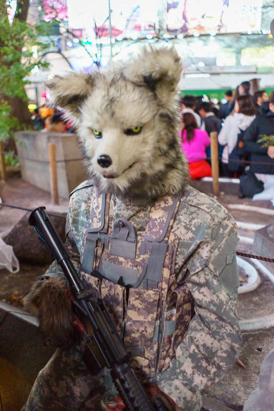 Japan-Tokyo-Halloween-Shibuya - A wolf with a real looking machine gun, it was an actual person but he would not move for a minute then move suddenly and frighten people.