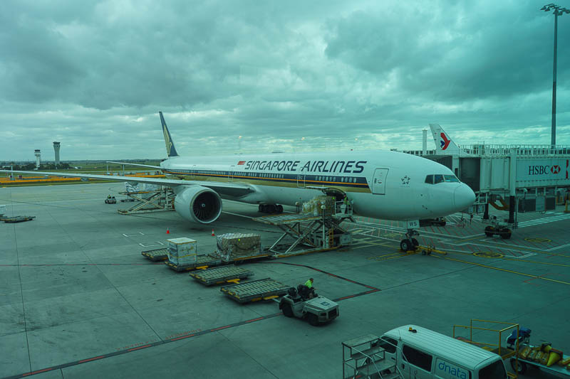 Melbourne-Singapore-Airport - Here is my plane, on the ground in Melbourne shot through tinted dirty glass. A Boeing 777, my second favorite plane to fly in economy on due to 9 abr