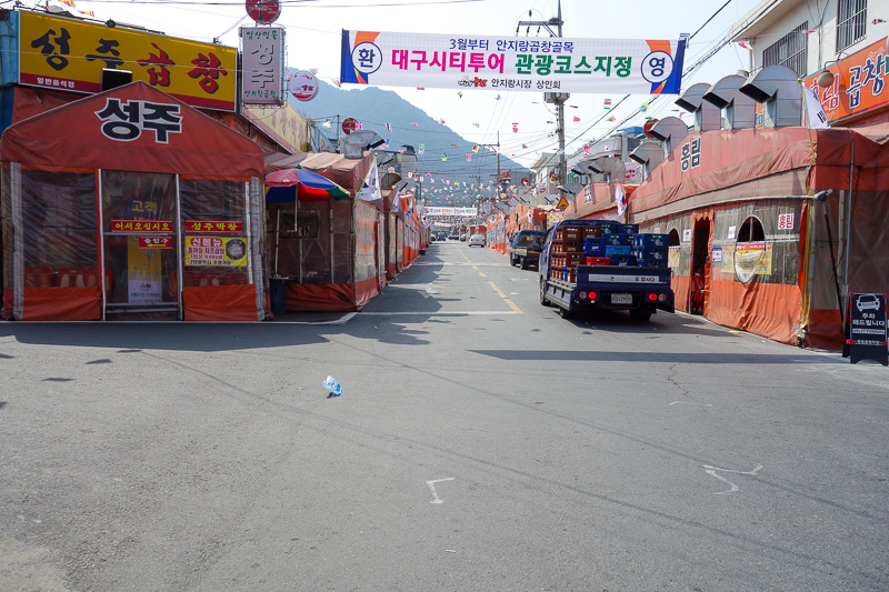 Korea again - Incheon - Daegu - Busan - Gwangju - Seoul - 2015 - This is number one restaurant street in all Daegu! Signs told me. Its currently orange plastic tent world. Alfresco dining. They have optimistically p