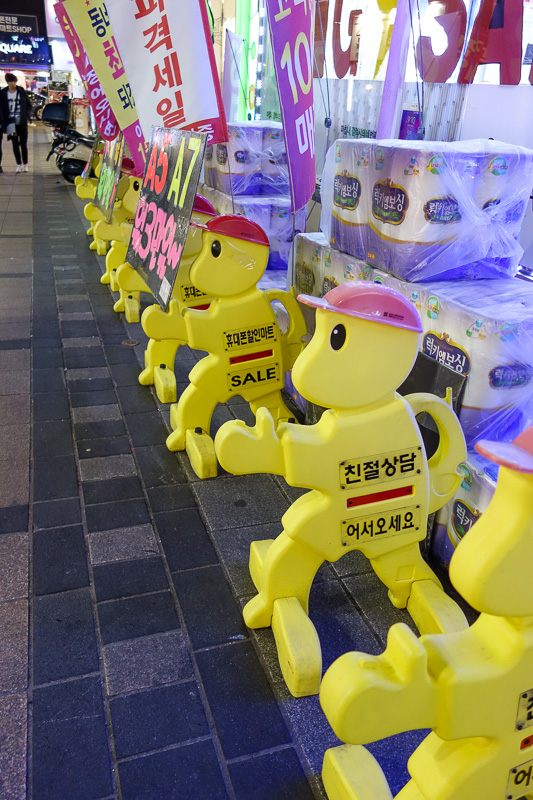 Korea again - Incheon - Daegu - Busan - Gwangju - Seoul - 2015 - Plastic yellow work men are doing good work all over Korea. Here they are particularly effective at guarding toilet paper.