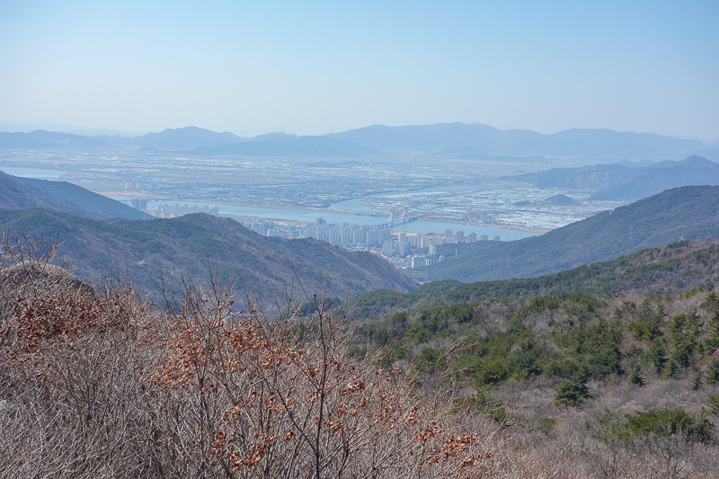 Korea-Busan-Hiking-Geumjung - And now, first glimpse of the other side of the mountain range. A great plain. With seas of presumably rice.