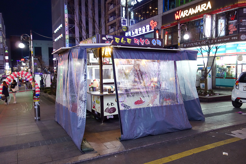 Korea again - Incheon - Daegu - Busan - Gwangju - Seoul - 2015 - This is a street restaurant. To operate in winter, they all erect tents around their cart, and burn lumps of coal in pots to generate heat. Most of th