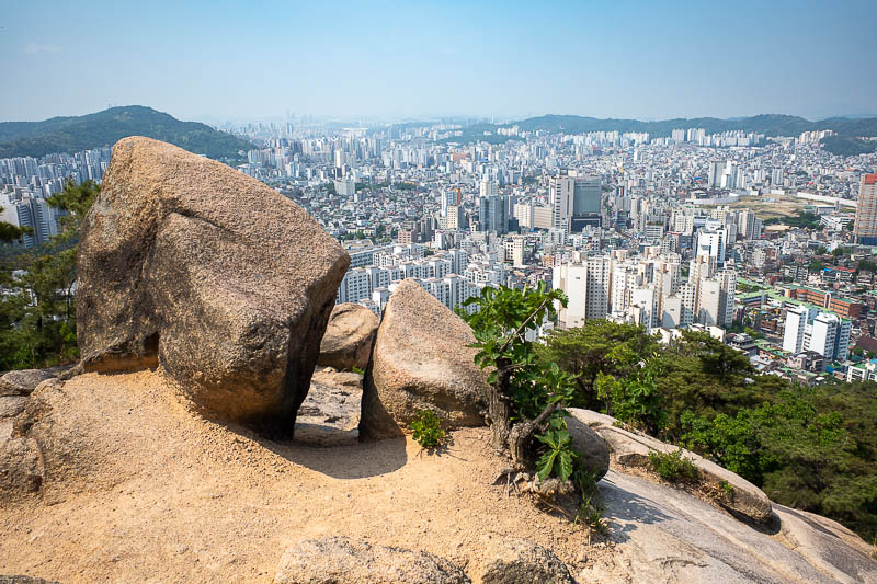 Korea for the 4th time - May and June 2022 - The view starts as soon as the hike does. The pollution was causing a bit of a twilight glow, causing these rocks to look orange.