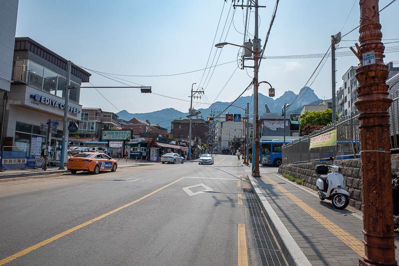 Korea-Seoul-Hiking-Bukhansan - Last pic of the day, those are some of the peaks in the background, squint to see through the pollution. The street leading up the entrance is full of