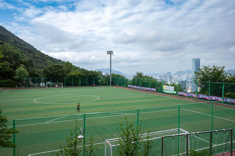 Korea-Busan-Hiking-Hwangnyeongsan - It is steep before even getting to a hiking trail, but there is still a sporting field to enjoy on the side of the mountain.
