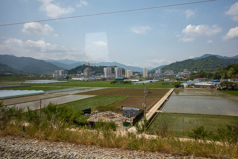 Korea-Busan-Yeosu-Train - The view was mountains, farms, tunnels. The farms still have high rise apartment buildings in Korea.