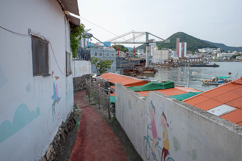 Korea-Yeosu-Food-Schnitzel - This is the road, they painted the pedestrian recommended access in red. It is suitable for bicycles also, murals of people riding bikes are painted o