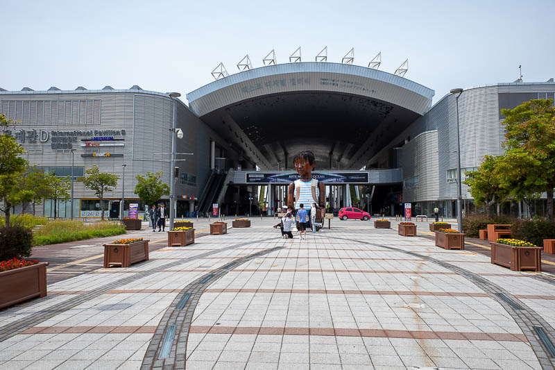 Korea-Yeosu-Seoul-Train - Now for the expo. Here is the main entrance, you are greeted by a giant brown small wooden boy. This is a Korean welcome to country, and the boy does 