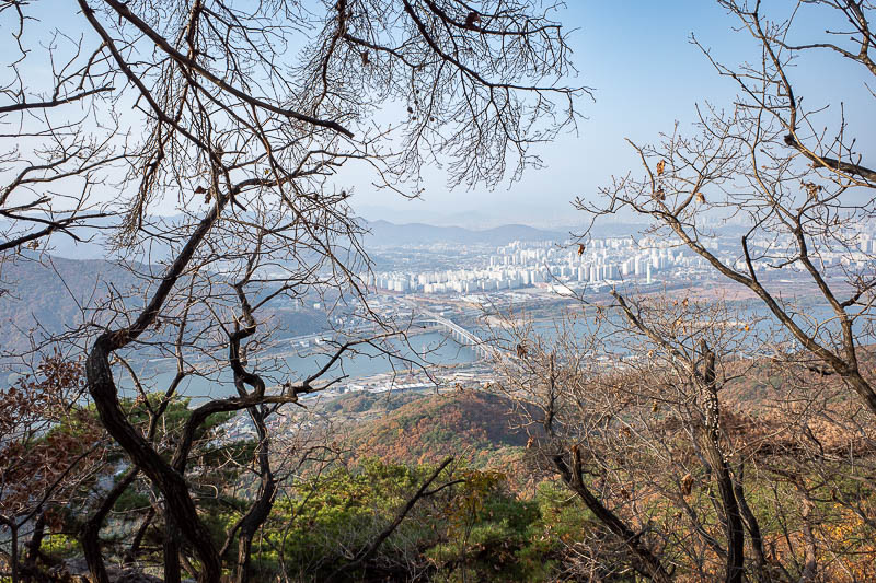 Korea-Seoul-Hiking-Yebongsan - A view back towards part of Seoul from part way up. The main parts of Seoul are further along the river to the right.