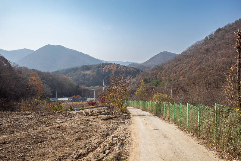 Korea-Seoul-Hiking-Geomdansan - After leaf swimming for an hour or so, I popped out into some farms. Those mountains across there are the ones from the day where I went up the hill o