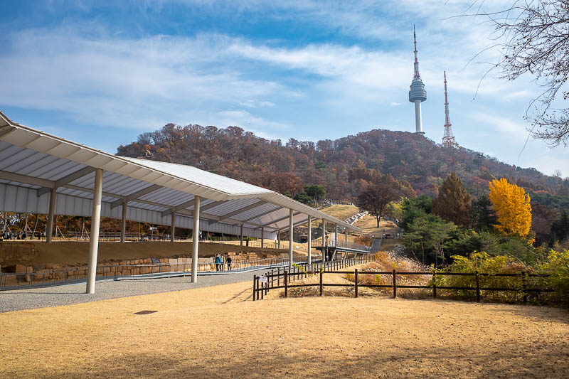 Korea-Seoul-Namsan-Protest - I am basically finished at this point. There is one last shot of the tower. Under the shed are some ancient ruins, better go investigate more closely.