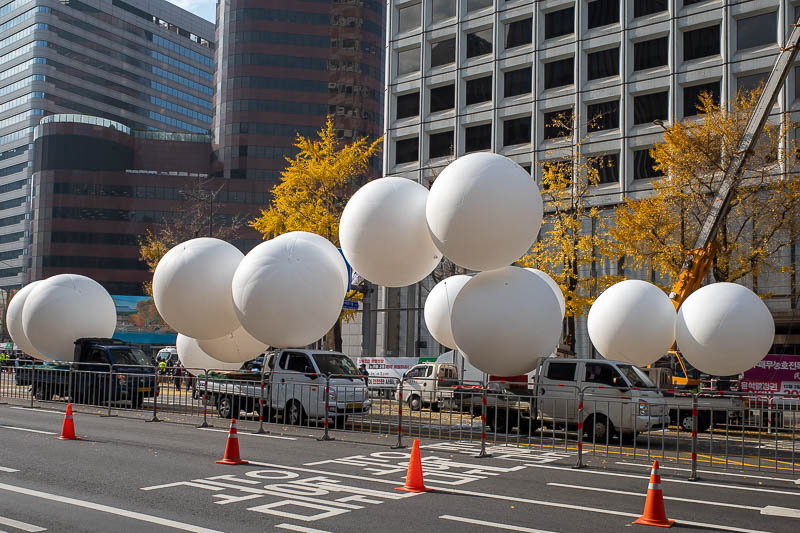 Korea-Seoul-Namsan-Protest - OK, it is protest time. These are weather balloons. They tie banners between two of them and attach them to trucks to float the big banners in the sky