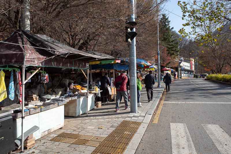 Korea twice in one year - November 2022 - You know you are in a popular hiking area when there is a street fall of unofficial shops selling shoes, tomatoes and vacuum cleaners.