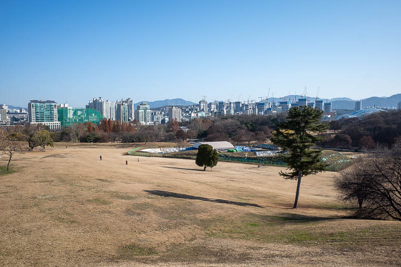 Korea-Seoul-Olympics - View from a hill. I think that area is an archaeological excavation site. Someone found an ancient running shoe. Look at all the cranes in the backgro