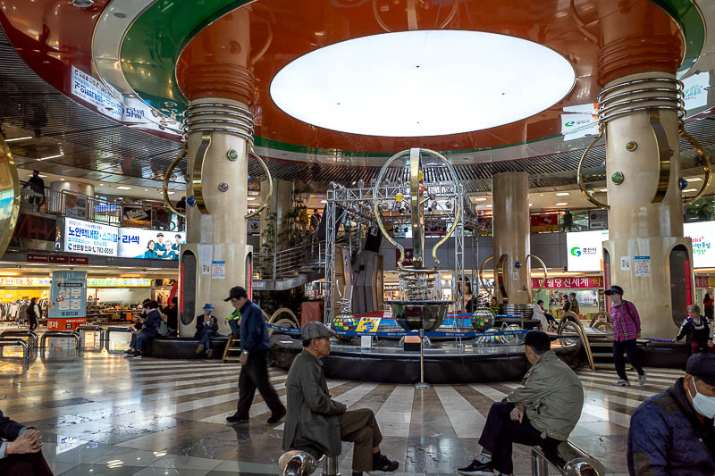 Korea-Daegu-Apsan - The whole area near my hotel is underground shopping streets. This one is 2 levels, periodically there is an atrium like this with robot art.