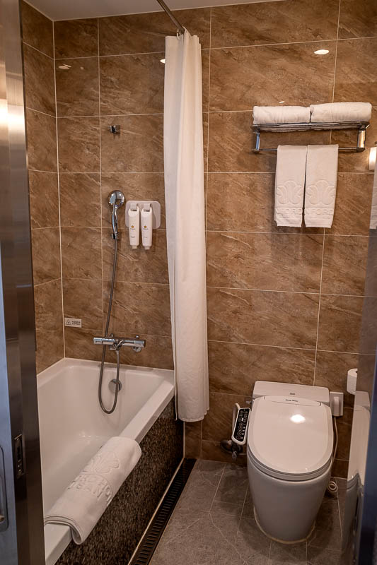 More of the same of Korea - March and April 2024 - And my bathroom with space toilet and full sized towels, the shower here drains into the bath, not across the floor. Many Korean hotels only give you 
