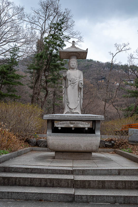 Korea-Seoul-Hiking-Yebongsan - The friendly skinny Buddha signals the end of the trail and the start of a road back to the station.