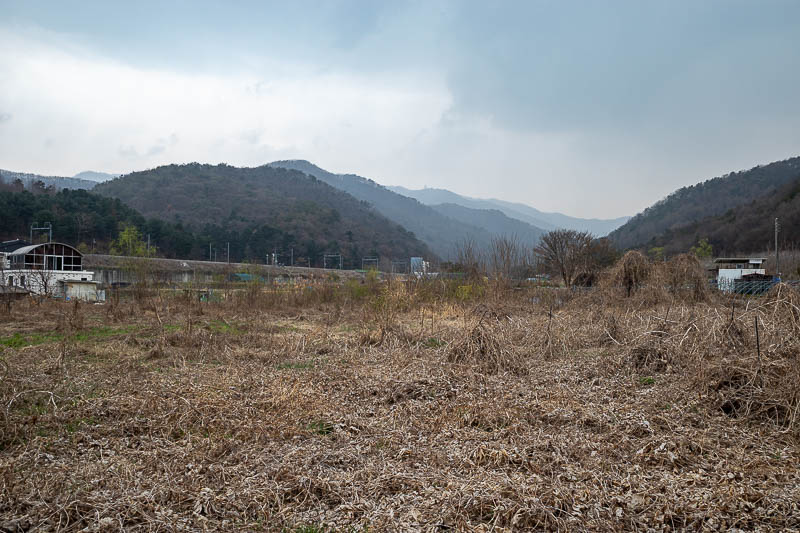 Korea-Seoul-Hiking-Yebongsan - I have taken a photo here in autumn when the field was full of crops. Those are the mountains I climbed along today.