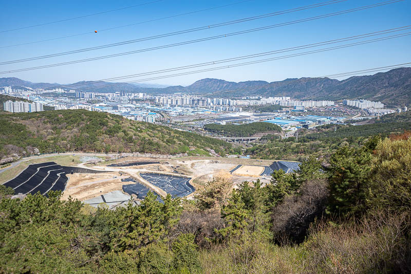 Korea-Changwon-Hiking-Jinhae - This is looking back in the direction of the main part of Changwon, where my hotel is. That looks like a rubbish dump. That would be an interesting ch