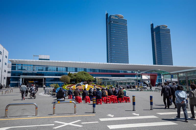 Korea-Changwon-Daejeon-KTX - Arriving at Daejeon station and there is a political rally and or cult meeting going on. The station looks newer than I remember, perhaps they have re