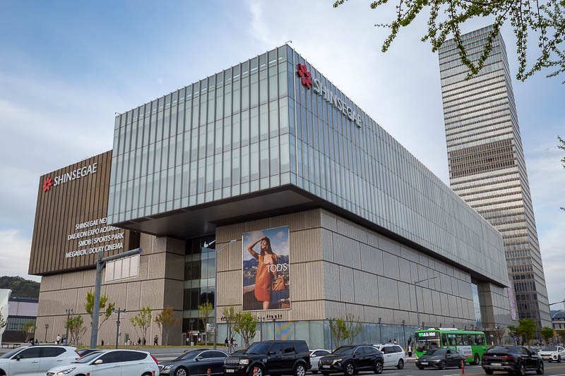 Korea-Daejeon-Shinsegae - It looks like a giant box. The woman in the ad appears to be wearing a leather smock.