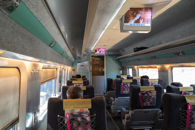 Korea-Daejeon-Jeonju-KTX - I had the single seat in first class again. No sick people today, but the blinds were all pulled down. There are free bottles of water and boxes of co