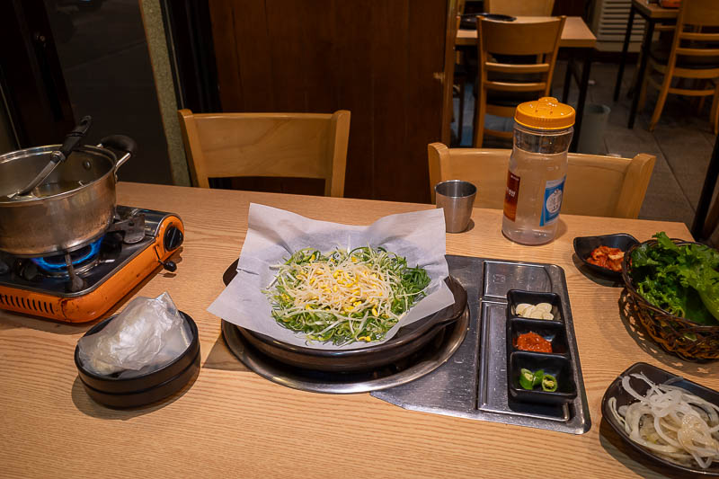 Korea-Jeonju-Hanok-Bulgogi - Now for my dinner. All this and more for about $10. So far we have green onions and bean shoots on hot plate number 1, and a saucepan of a few mushroo