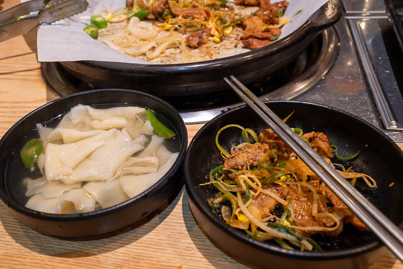 Korea-Jeonju-Hanok-Bulgogi - And now the piece de resistance, while I was eating my bulgogi, the boss lady came over, put on disposable plastic gloves, and peeled bits of dough of