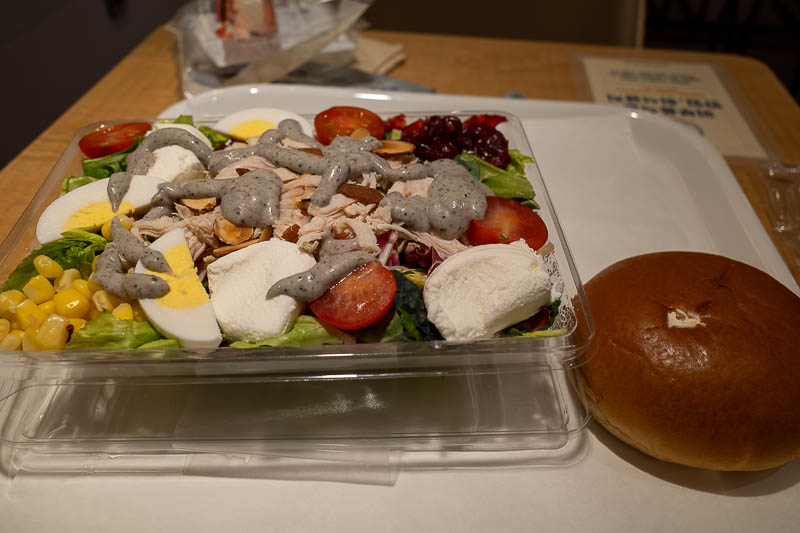 Korea-Seoul-Museum-Market - A rare treat. A photo of my lunch. A salad and a coffee bun. The horrible looking grey dressing I chose is pepper and black sesame, and I have to say,