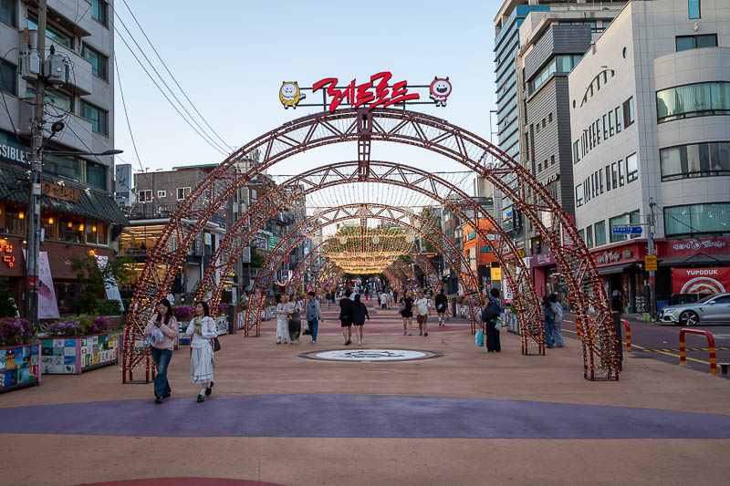 Korea-Seoul-Hongdae - Time to start the traverse of the red road. Arches announce the start point.